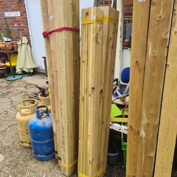 Three bundles of 5ft timber ready for construction projects.