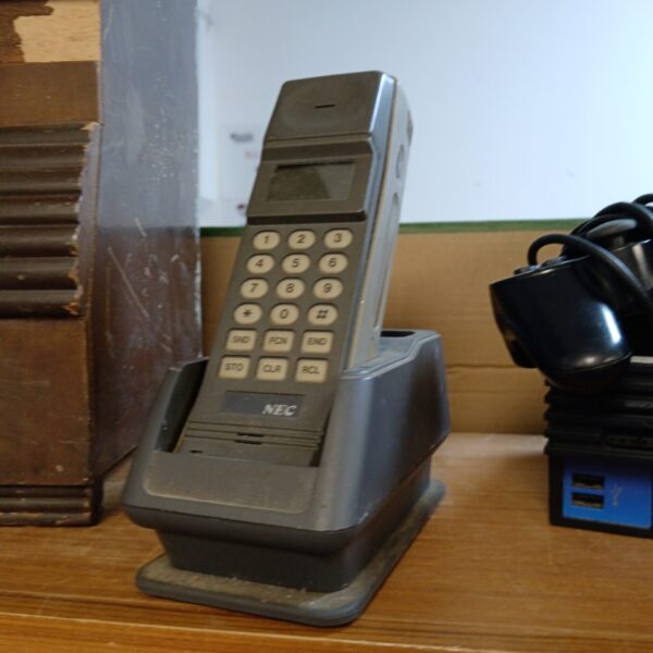 Vintage NEC BC-410 mobile phone on display.