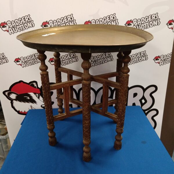 Vintage Egyptian folding table with brass charger and carved base.