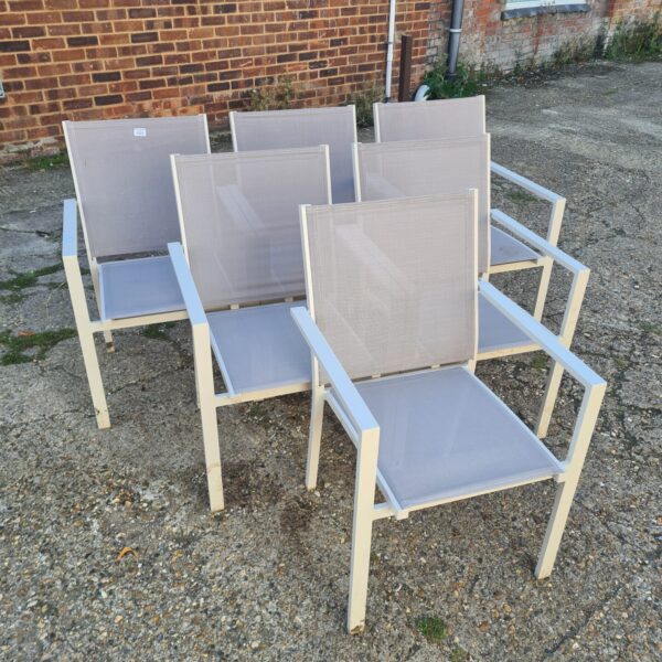 Lot of six stackable metal garden chairs for outdoor use.