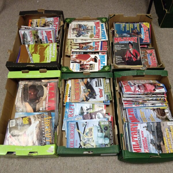 Tray of vintage military modeling magazines, including model aircraft publications.