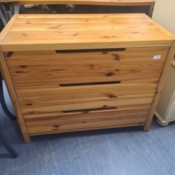Vintage pine chest of drawers with sliding drawers for bedroom storage.