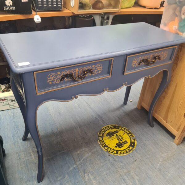 Blue French console table with carved details and a single drawer.