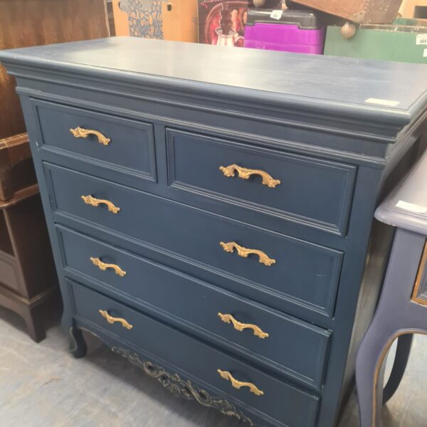 Vintage blue painted chest of drawers for bedroom storage.