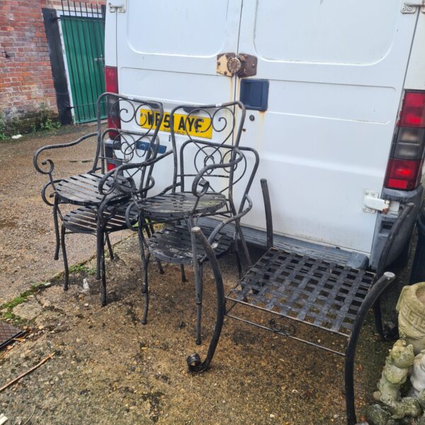 Vintage cast iron garden furniture set with table and chairs.