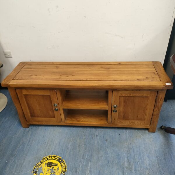 Front view of a vintage oak media cabinet with open shelving.