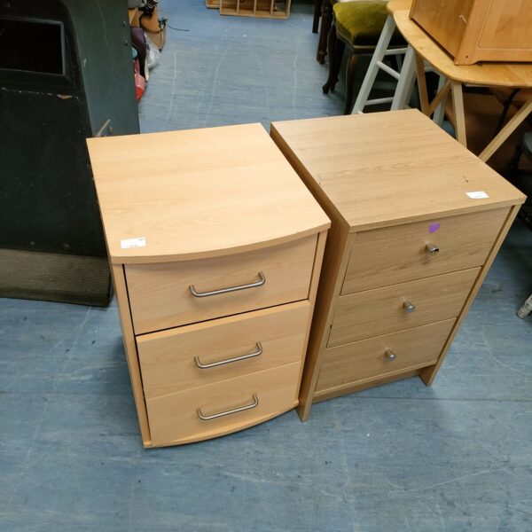 Pair of wooden bedside cabinets with three drawers.