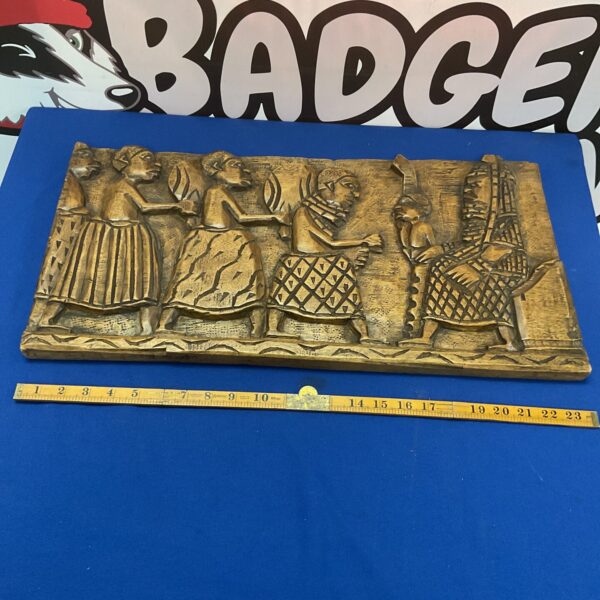 Vintage African carved wall plaque with detailed figures and animals.