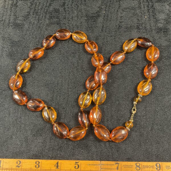 Close-up of a vintage amber-coloured bead necklace.