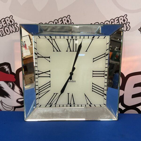 Vintage mirror wall clock with Roman numerals for retro home decor.