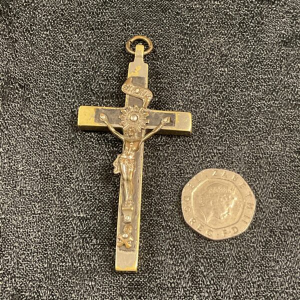 Antique ecclesiastical crucifix pendant, detailed religious art.