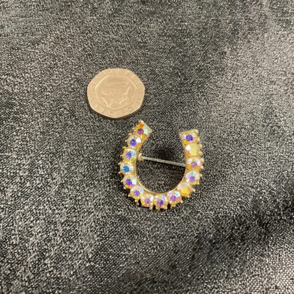 Vintage 1950s horseshoe brooch with sparkling rhinestones.