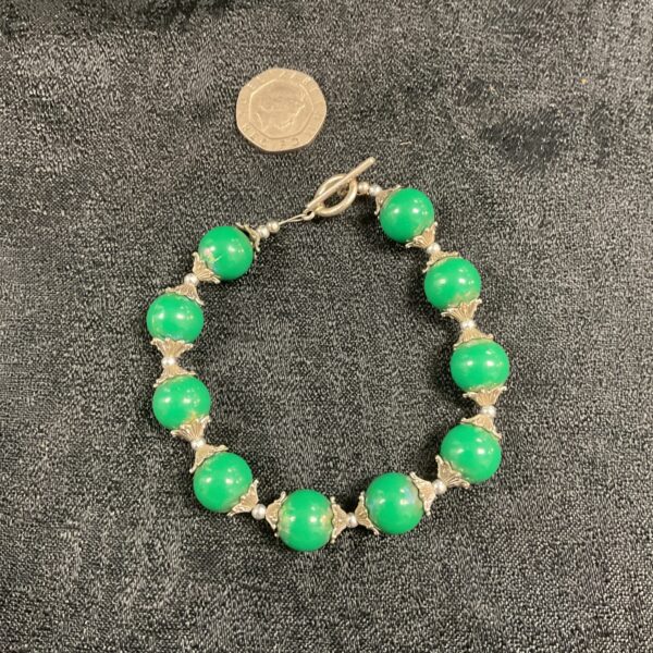 Vintage jadite bead bracelet with silver tone spacers.