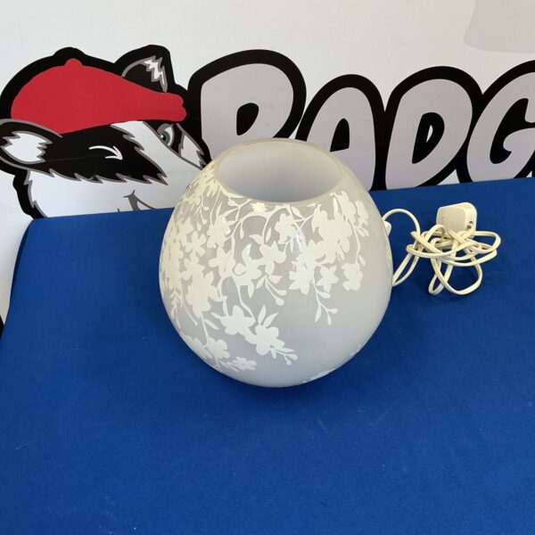 Vintage ceramic table lamp with floral design for home decor.