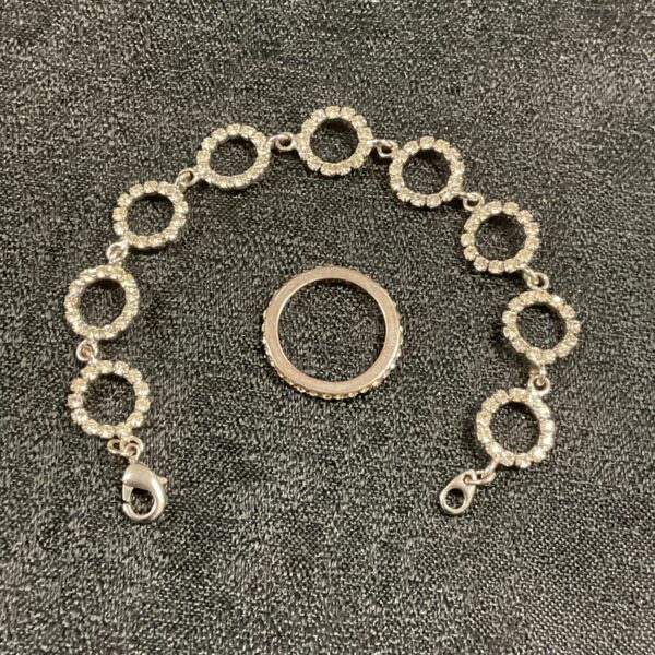 Vintage gold eternity ring and matching bracelet set on display.