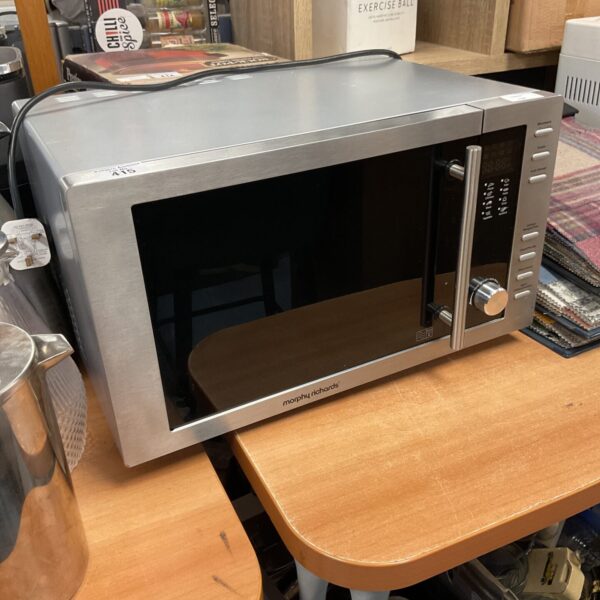Silver Morphy Richards microwave oven on a countertop.