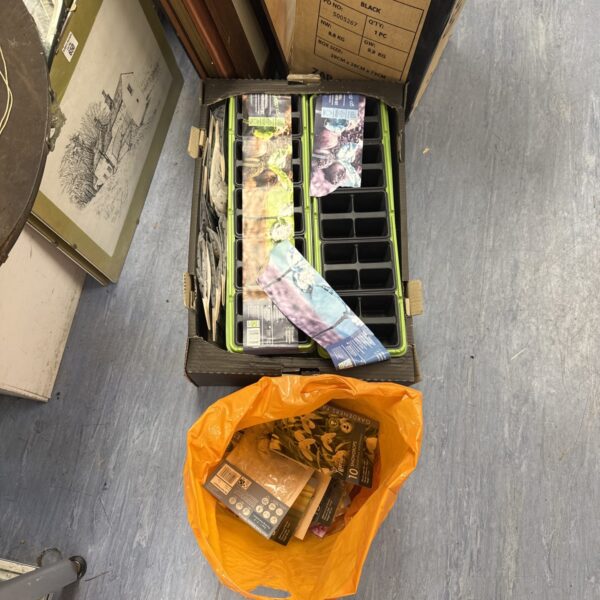 Mixed lot of seedling trays and assorted seeds for gardening.