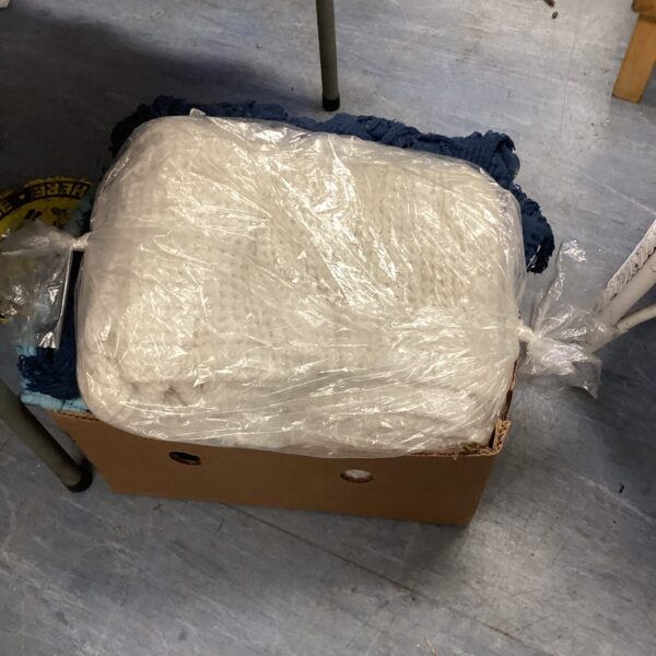 Bundled lot of assorted blankets for storage or use.
