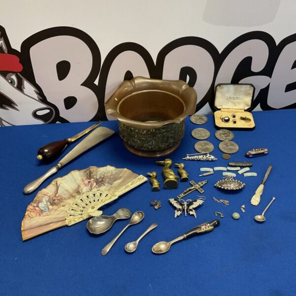 Vintage curios and jewellery displayed in an Arts & Crafts copper pot.
