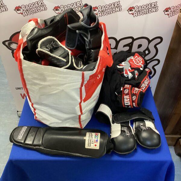 Mixed martial arts sparring kit with pads and clothing.
