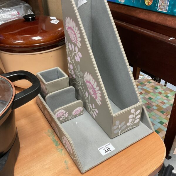 Front view of a floral patterned desk organiser with three compartments.