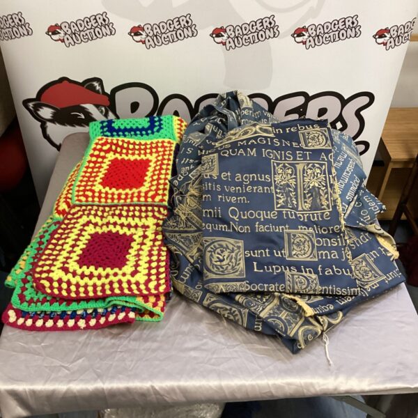 Bright colourful patchwork blanket with gothic style curtains.