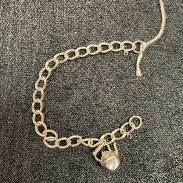 Vintage silver charm bracelet with teapot detail.