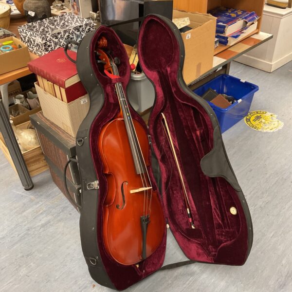 1/2 size cello in a hard case, student musical instrument.