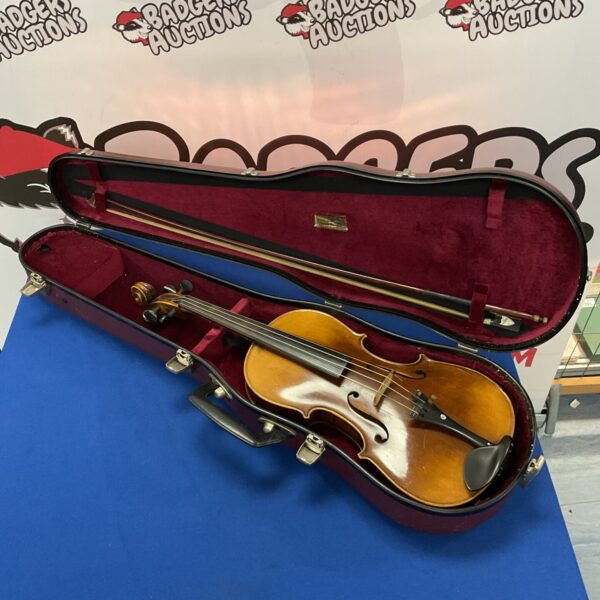 Vintage German violin replica in a protective case.