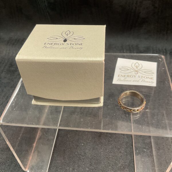 Silver spinner ring with a twist wire design.