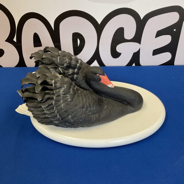 Elegant Franklin Mint black swan porcelain sculpture on display.