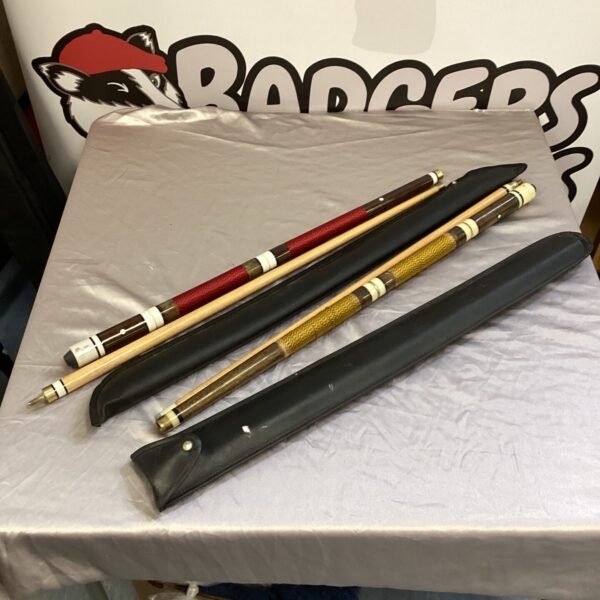 Pair of vintage snooker cues for billiards and game rooms.