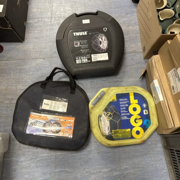 Thule XG-12 Pro car snow chains in packaging, winter vehicle safety.