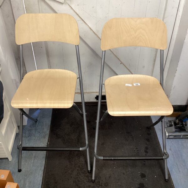 Vintage folding bar stools with metal frames and circular seats.