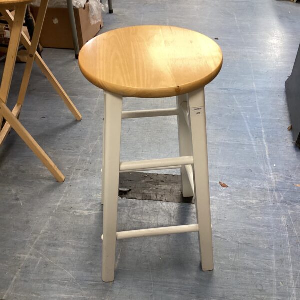 Rustic wooden stool with circular seat, ideal for kitchen or farmhouse style.