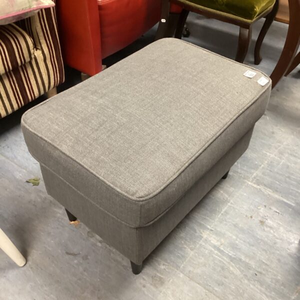 Grey upholstered footstool, comfortable footrest for living room.