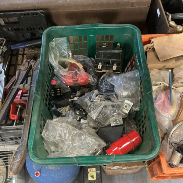 Crate of military toggle switches and electrical components.