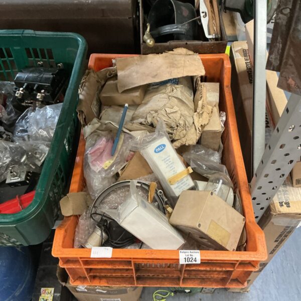 Assorted military spare parts in a green box.