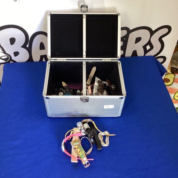 Vintage metal storage box filled with watches and straps.