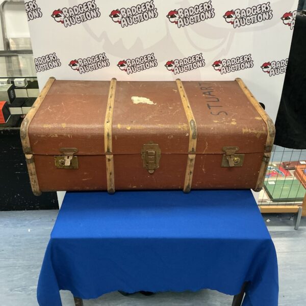 Large vintage trunk with metal corner protectors.