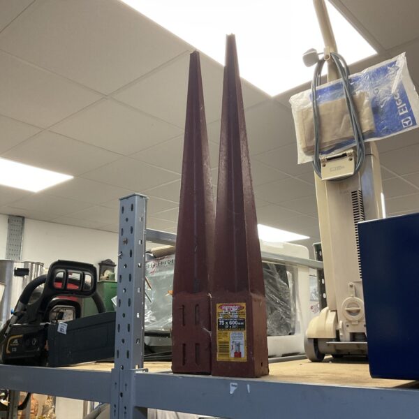 Pair of metal fence post stakes for garden use.