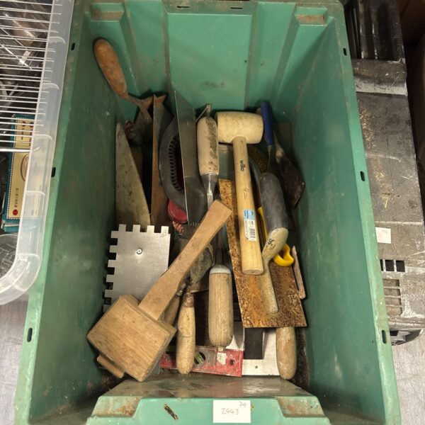 Assorted hand tools in a crate, vintage and modern implements.