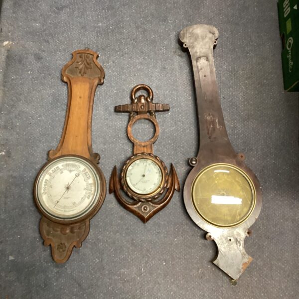 Lot of three antique oak barometers for weather forecasting.