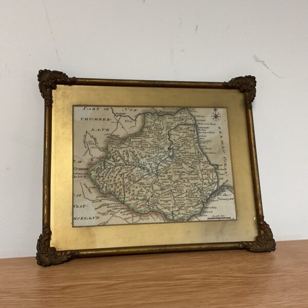 Antique hand-coloured map of Lincolnshire in a brass frame.