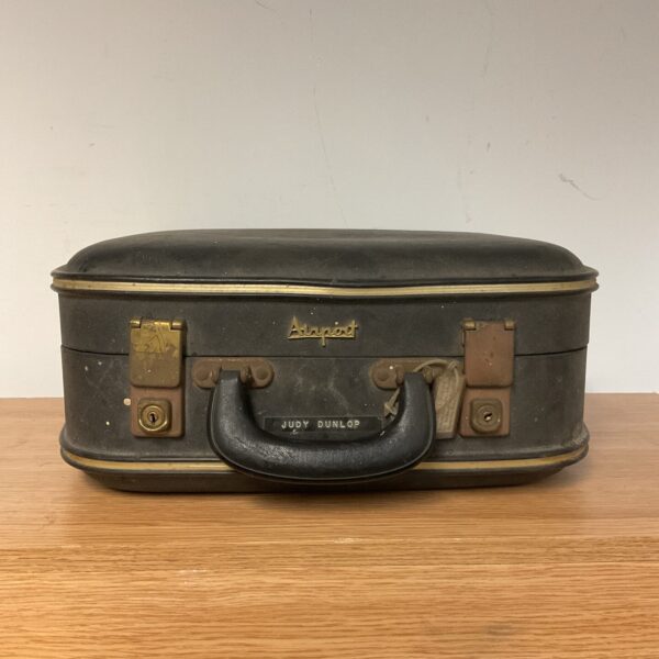 Dark vintage airport travel case with handle, owned by the Dunlop family.