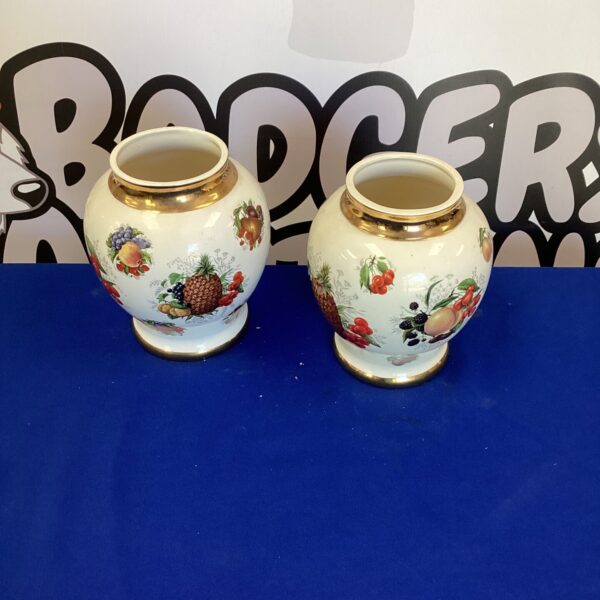 Antique Staffordshire vases with vibrant floral patterns.