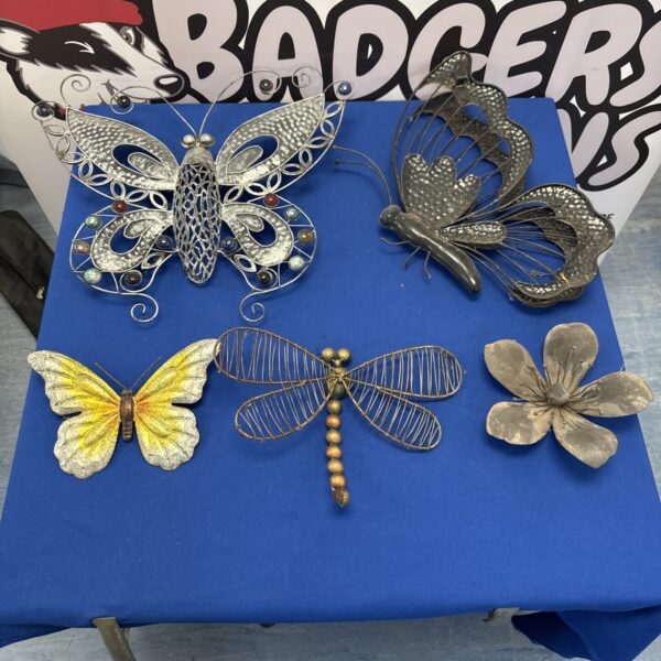 Decorative metal garden ornaments, including butterflies and dragonflies.