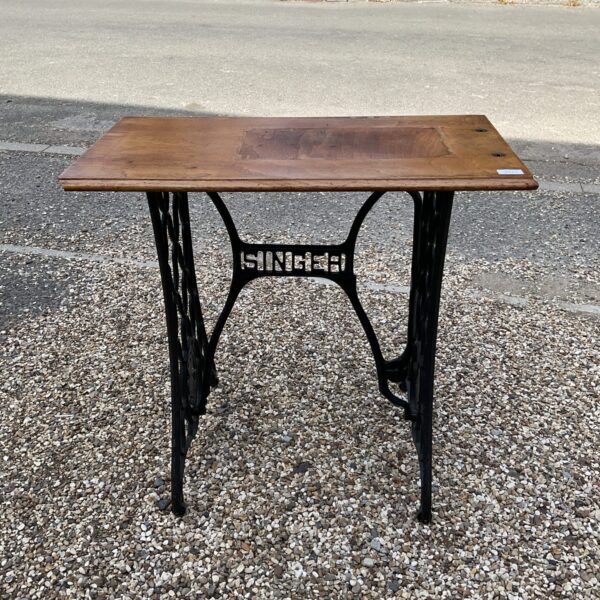 Antique Singer treadle base table with wooden top.