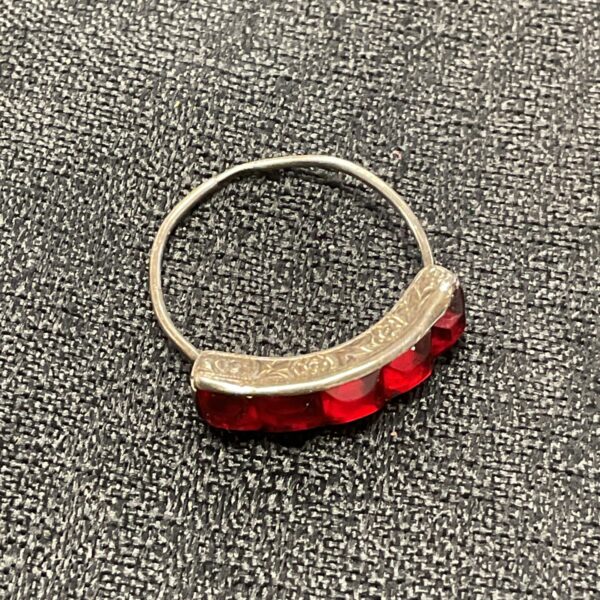 Close-up of a vintage silver ring with red garnets.