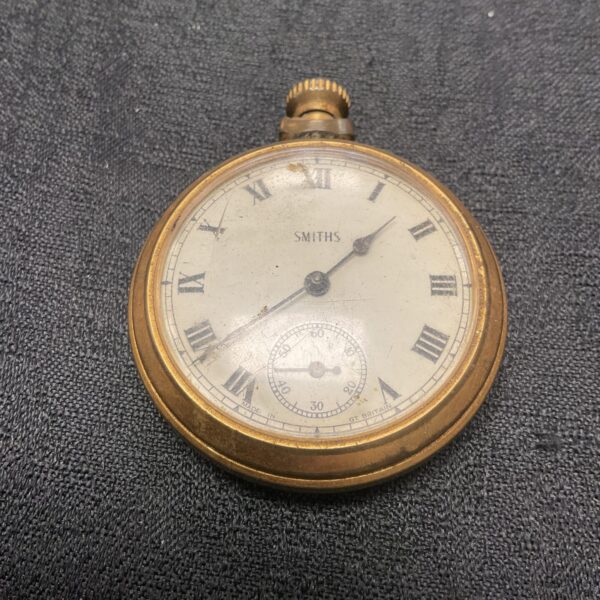 Vintage Smiths pocket watch with Roman numerals and silver case.